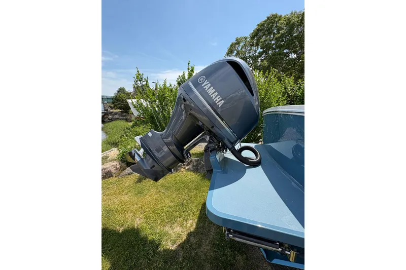 Slide: The Image of 2017 Regulator 23 Forward Seating boat with Yamaha outboard motor in a scenic outdoor setting. - 16