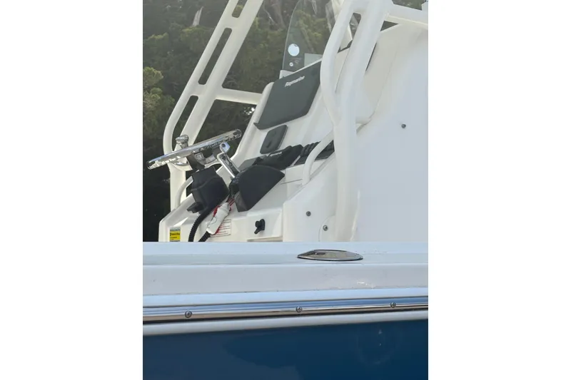 Slide: The Image of 2017 Regulator 23 Forward Seating boat helm with steering wheel and controls. - 17