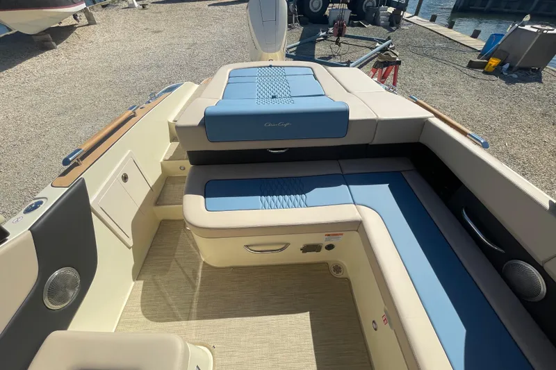 Slide: The Image of 2026 Chris-Craft Sportster 28 boat interior with blue and beige seating, elegant design. - 17