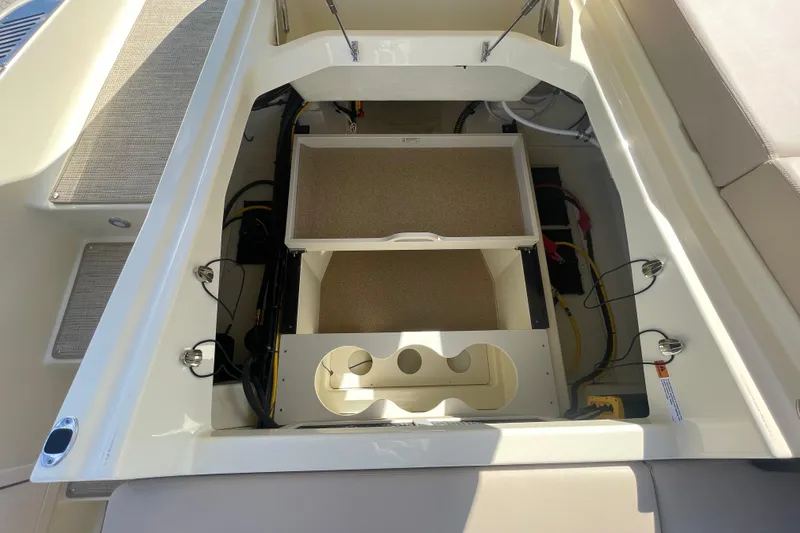 Slide: The Image of 2026 Chris-Craft Sportster 28 boat interior with blue seating and wooden accents. - 19