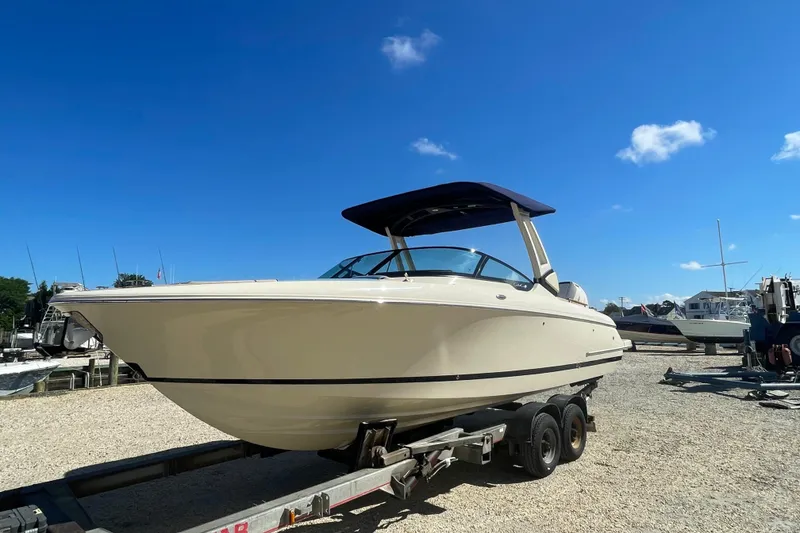 Slide: The Image of 2026 Chris-Craft Sportster 28 boat displayed indoors with Yamaha signage and American flag. - 2
