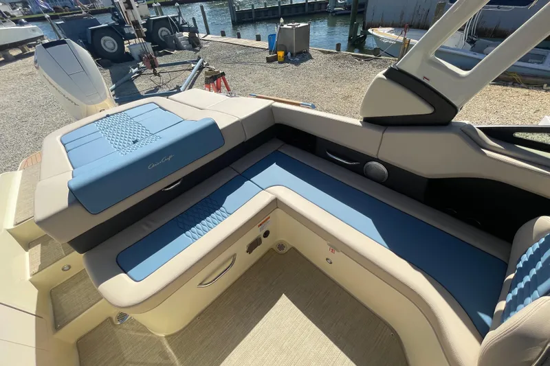 Slide: The Image of 2026 Chris-Craft Sportster 28 boat interior with open engine compartment, dockside view. - 22