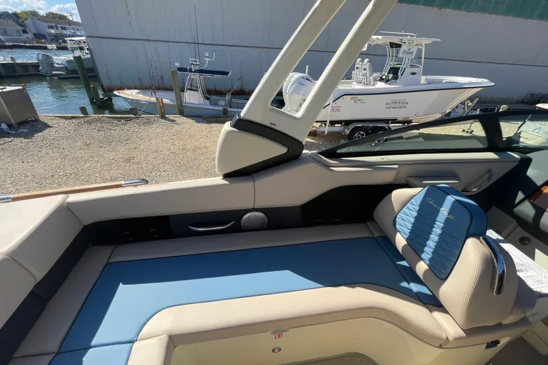 Slide: The Image of 2026 Chris-Craft Sportster 28 boat storage compartment with organized wiring and cup holders. - 23