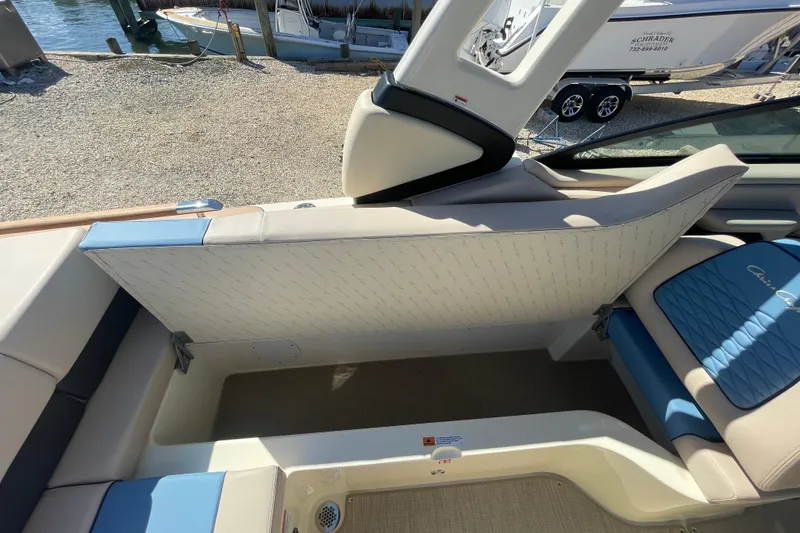 Slide: The Image of 2026 Chris-Craft Sportster 28 interior storage compartment with wiring and seating. - 24