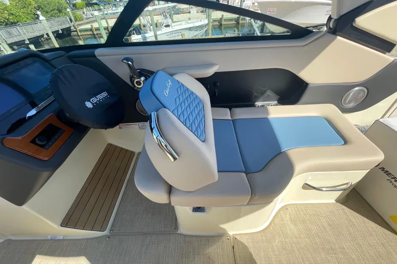 Slide: The Image of 2026 Chris-Craft Sportster 28 interior with blue and beige seating, modern design. - 30