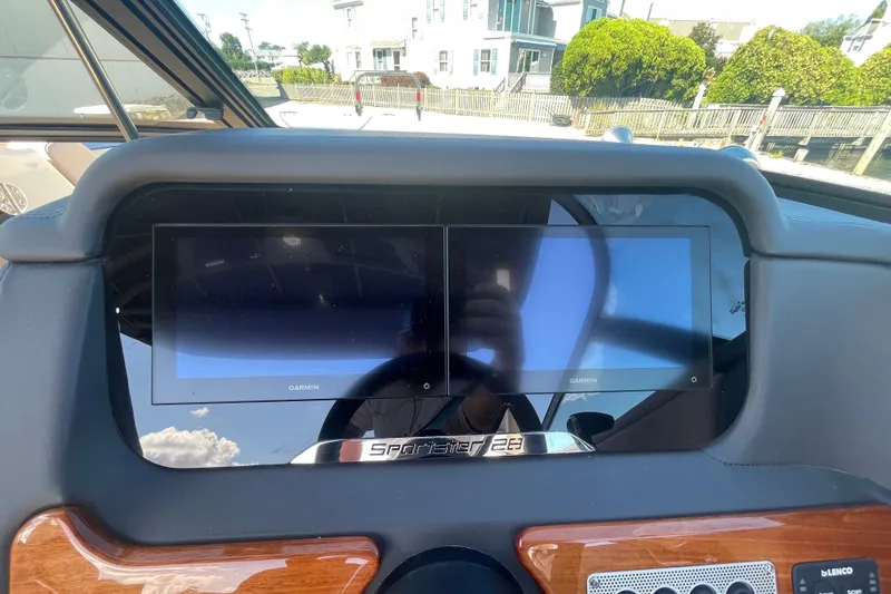 Slide: The Image of 2026 Chris-Craft Sportster 28 throttle control with start/stop button and speaker detail. - 36