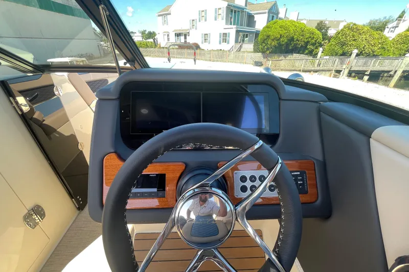 Slide: The Image of 2026 Chris-Craft Sportster 28 dashboard with control panel and Lenco trim tab switches. - 37