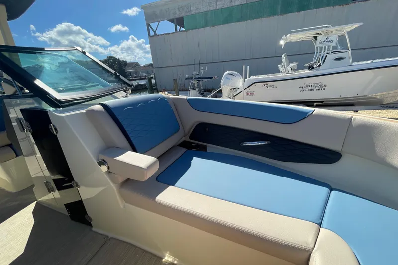 Slide: The Image of 2026 Chris-Craft Sportster 28 interior bathroom with toilet, mirror, and hooks. - 50