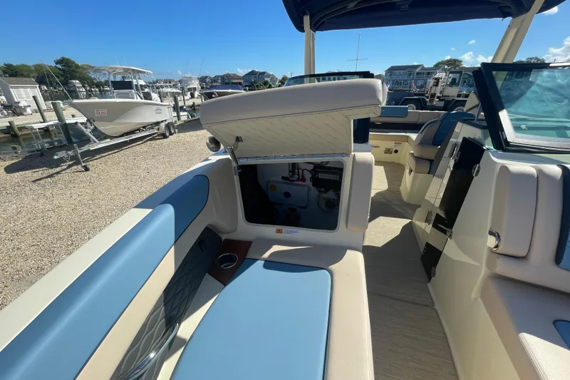 Slide: The Image of 2026 Chris-Craft Sportster 28 boat interior with blue and beige seating. - 56