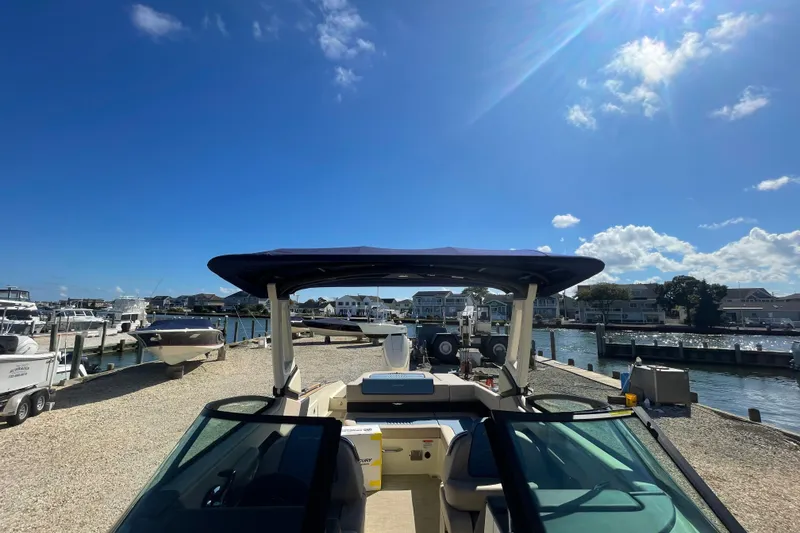 Slide: The Image of 2026 Chris-Craft Sportster 28 interior with blue seating and sleek design. - 57