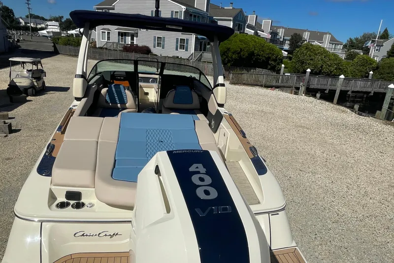 Slide: The Image of 2026 Chris-Craft Sportster 28 boat on trailer under clear blue sky. - 6