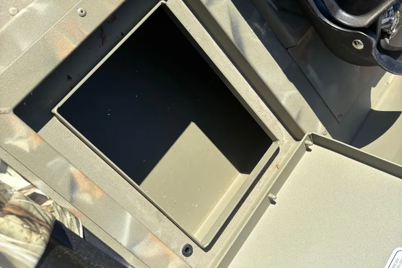 Slide: The Image of Open storage compartment on 2024 Tracker Grizzly 1754 SC boat. - 13