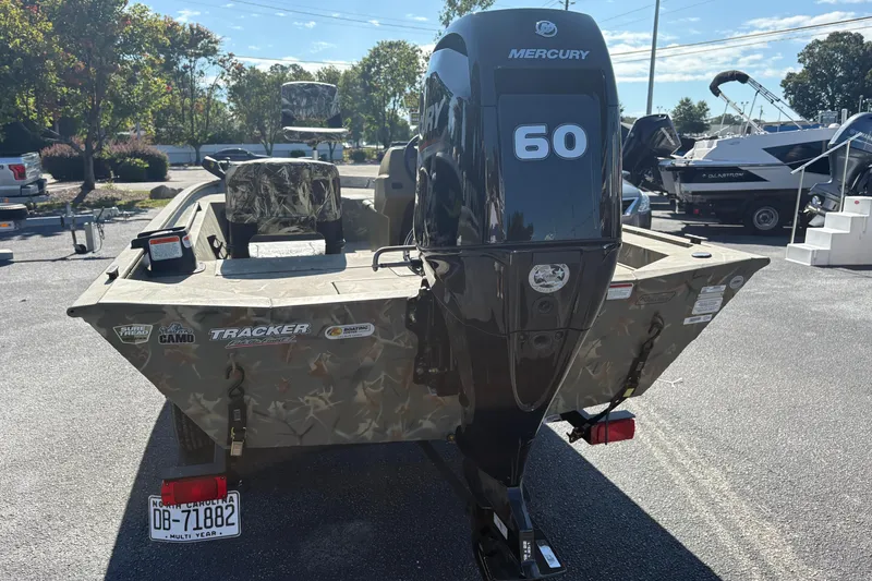 Slide: The Image of 2024 Tracker Grizzly 1754 SC boat with Mercury 60 engine, parked outdoors. - 18