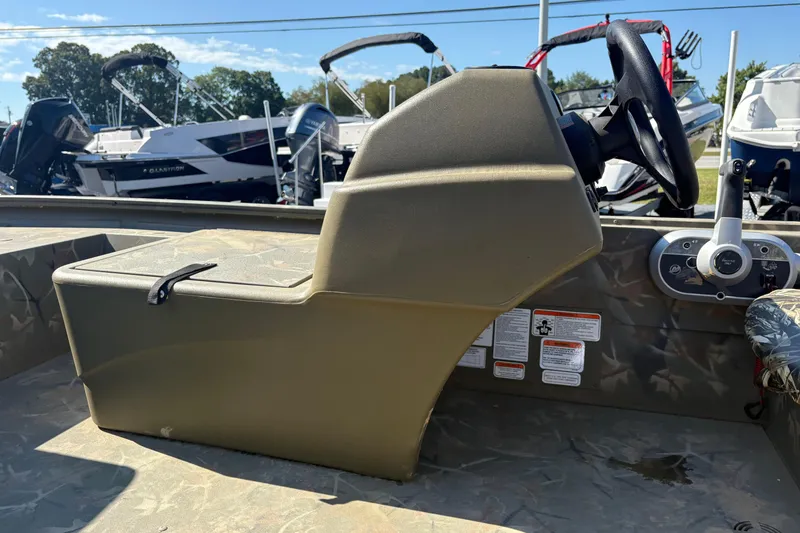 Slide: The Image of 2024 Tracker Grizzly 1754 SC boat console with steering wheel and controls. - 20