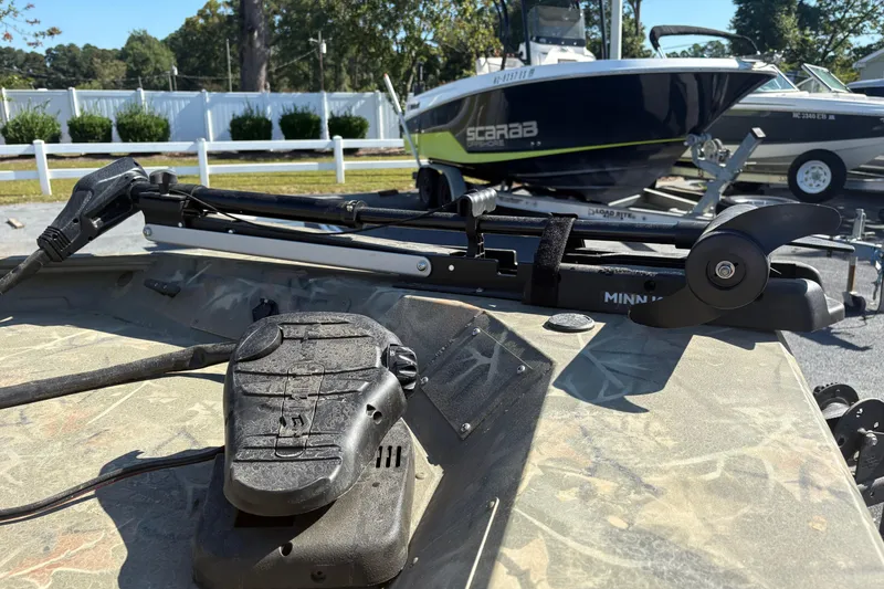 Slide: The Image of 2024 Tracker Grizzly 1754 SC boat with Minn Kota trolling motor on deck. - 7