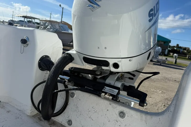 Slide: The Image of 2026 C-Hawk 190 Center Console SPL boat with Suzuki outboard motor in a marina setting. - 9