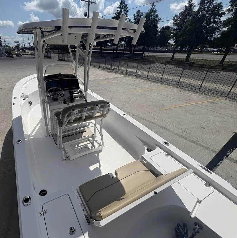 Slide: The Image of 2016 Sportsman Masters 247 Bay Boat with T-top and seating, docked at a marina. - 4