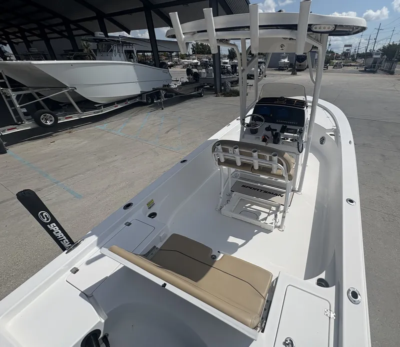Slide: The Image of 2016 Sportsman Masters 247 Bay Boat cockpit with steering wheel and control panel. - 5