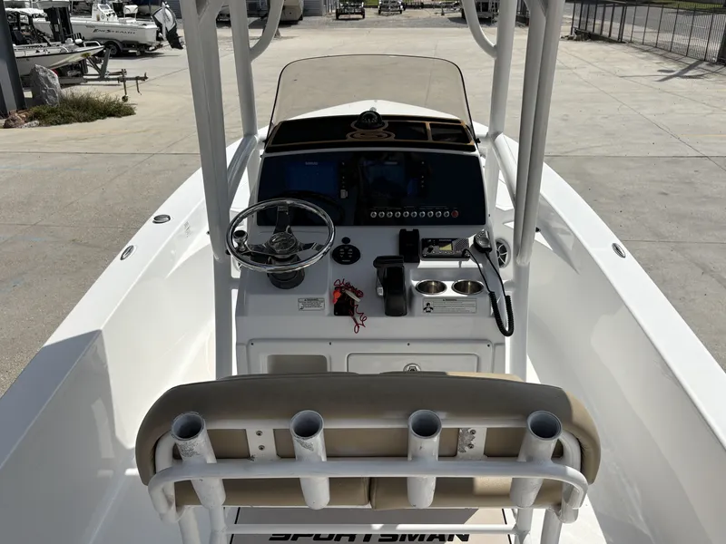 Slide: The Image of 2016 Sportsman Masters 247 Bay Boat interior with beige seating and steering wheel. - 6