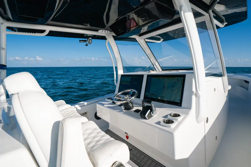 Slide: The Image of 2023 Front Runner 39 Center Console boat interior with ocean view, featuring modern navigation displays. - 12
