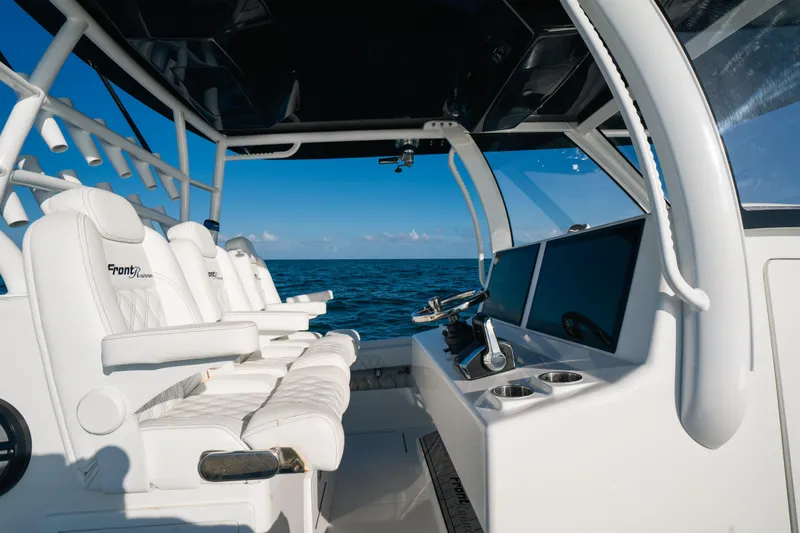 Slide: The Image of 2023 Front Runner 39 Center Console boat interior with white seating and ocean view. - 17