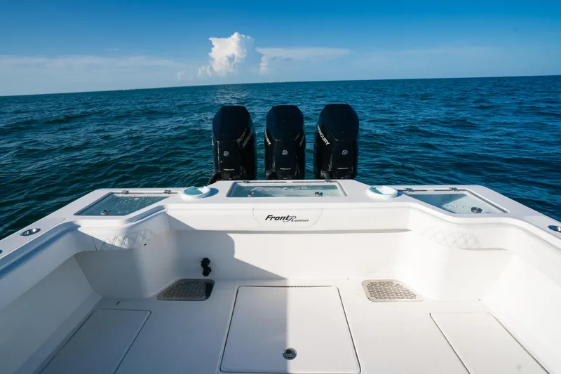 Slide: The Image of 2023 Front Runner 39 Center Console boat with triple outboard engines on open sea. - 19