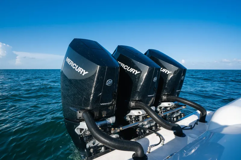 Slide: The Image of Triple Mercury outboard engines on 2023 Front Runner 39 Center Console boat in open sea. - 20