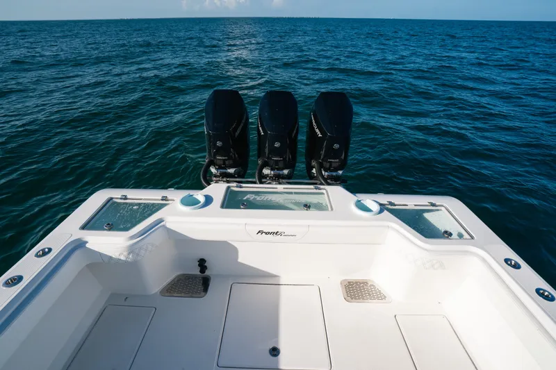 Slide: The Image of 2023 Front Runner 39 Center Console boat with triple outboard engines on open sea. - 21