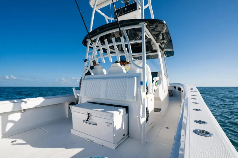 Slide: The Image of 2023 Front Runner 39 Center Console boat cruising on open ocean under clear blue sky. - 22