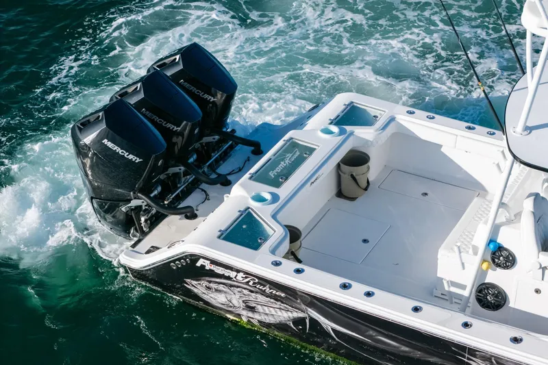 Slide: The Image of 2023 Front Runner 39 Center Console boat with triple Mercury engines on the water. - 4