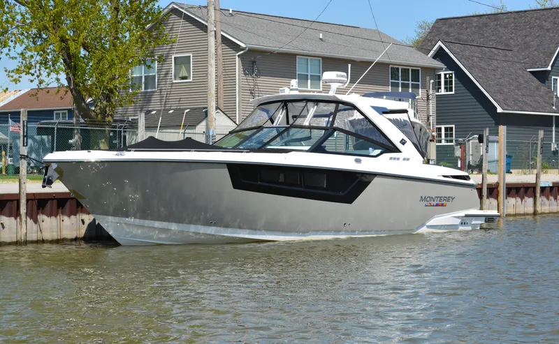 The Image of 2024 Monterey 378 Super Sport boat docked near waterfront homes. - 0