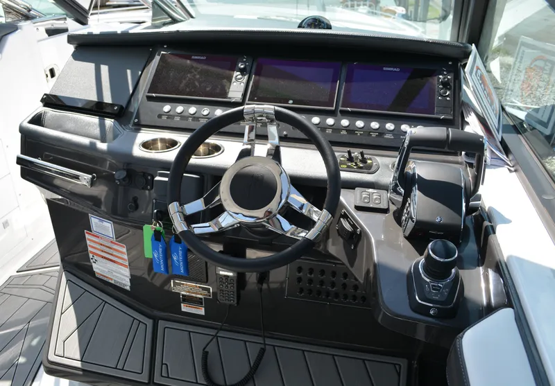 Slide: The Image of 2024 Monterey 378 Super Sport boat dashboard with steering wheel and control panel. - 13