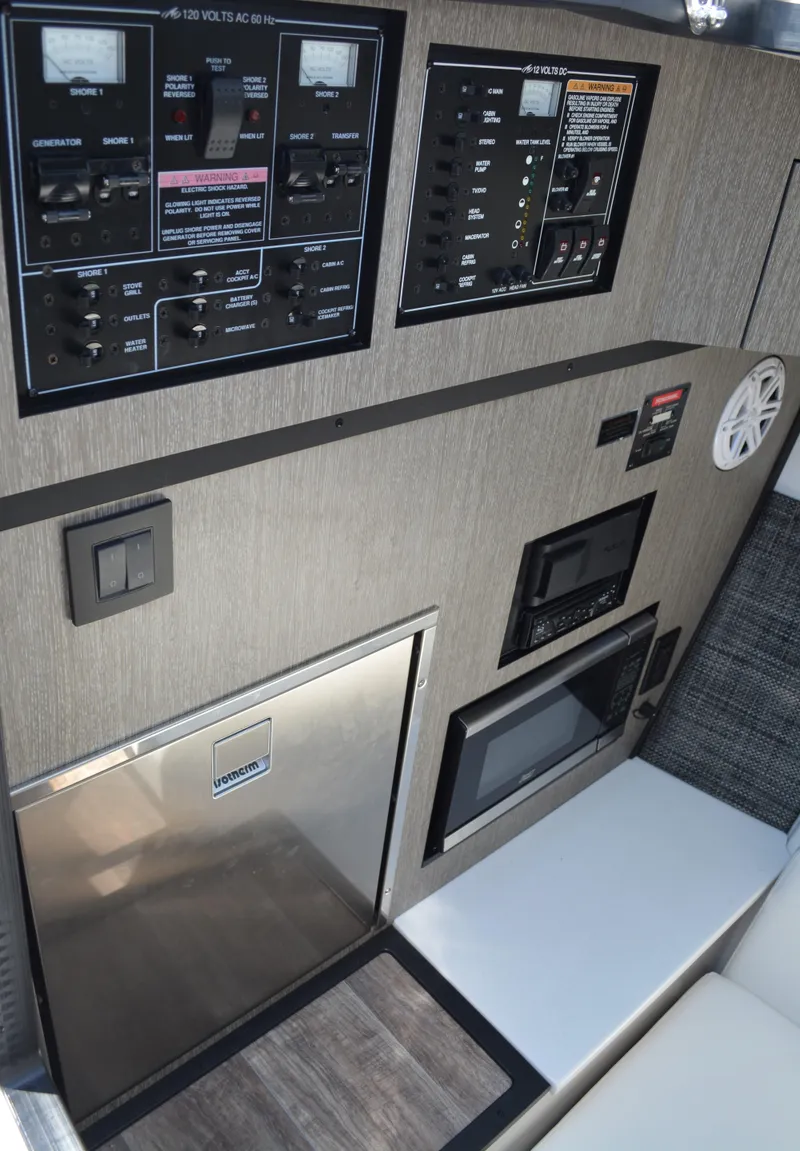 Slide: The Image of 2024 Monterey 378 Super Sport control panel and galley area with microwave and refrigerator. - 17
