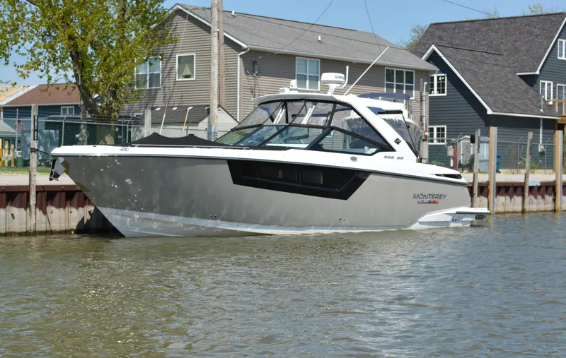 Slide: The Image of 2024 Monterey 378 Super Sport boat docked near waterfront homes. - 2