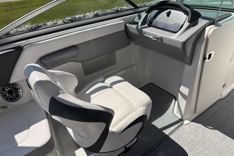 Slide: The Image of 2021 Chaparral 23 Surf boat interior with sleek helm and comfortable seating. - 10
