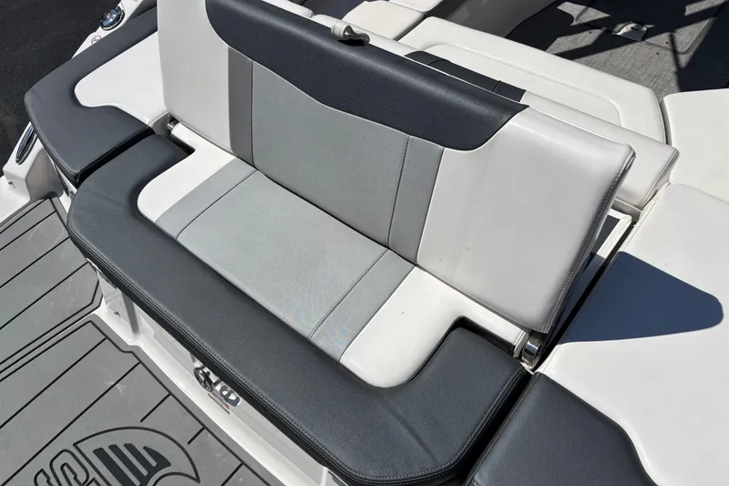 Slide: The Image of 2021 Chaparral 23 Surf boat seat with gray and black upholstery. - 12