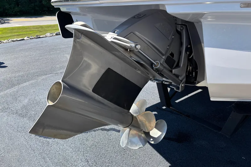 Slide: The Image of Close-up of 2021 Chaparral 23 Surf boat propeller and outdrive on pavement. - 4