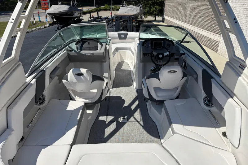 Slide: The Image of 2021 Chaparral 23 Surf boat interior with modern seating and steering console. - 6