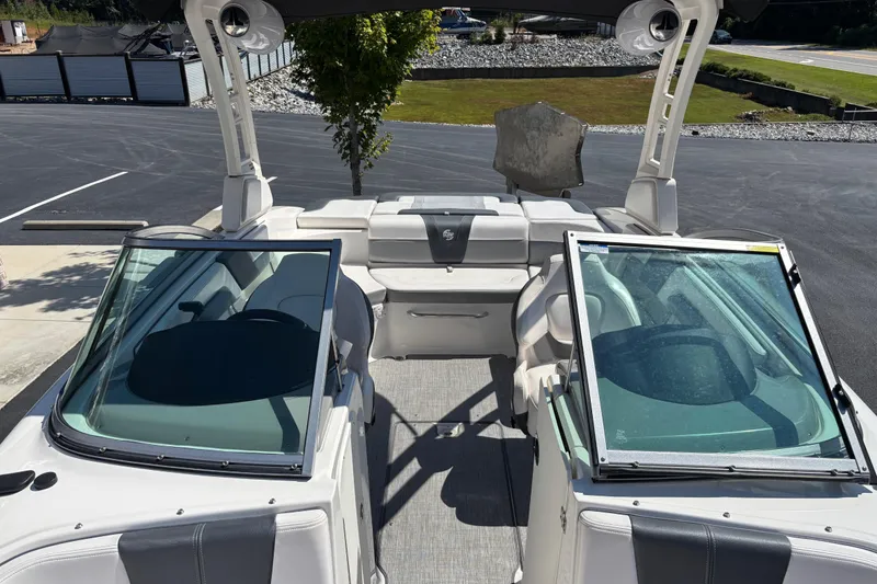 Slide: The Image of 2021 Chaparral 23 Surf boat interior with open windshield and seating area. - 7