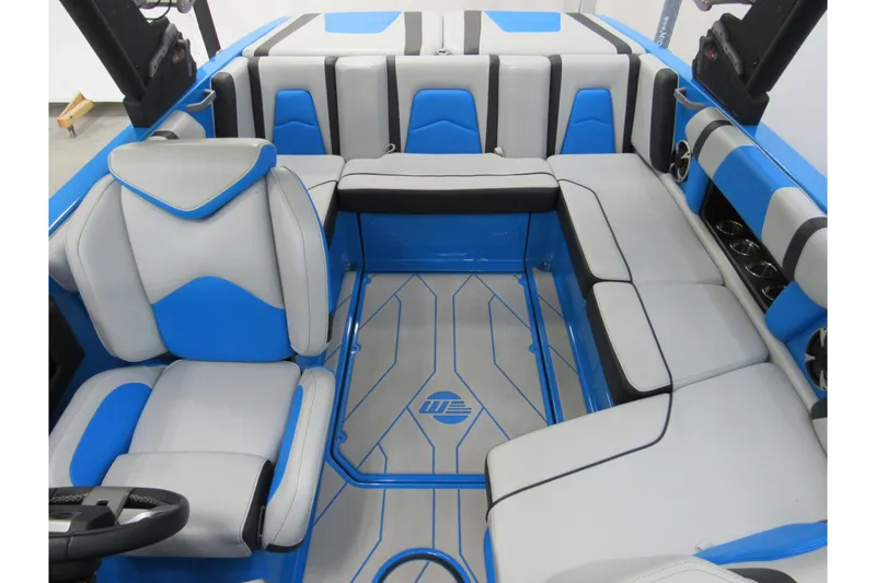 Slide: The Image of 2021 Malibu Wakesetter 21 MLX interior with blue and gray seating, modern design. - 11