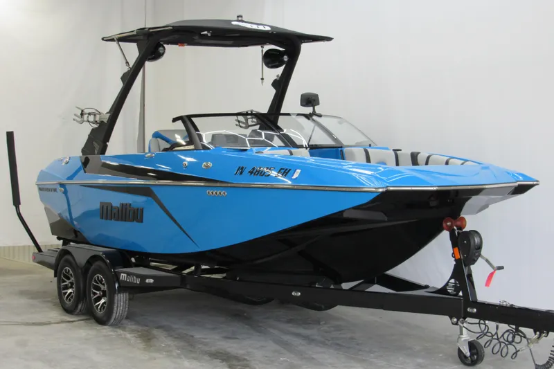 Slide: The Image of 2021 Malibu Wakesetter 21 MLX boat in vibrant blue on a trailer. - 3