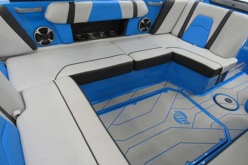 Slide: The Image of 2021 Malibu Wakesetter 21 MLX interior with blue and gray seating and speakers. - 6