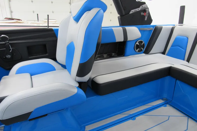 Slide: The Image of 2021 Malibu Wakesetter 21 MLX interior with blue and gray seating. - 7