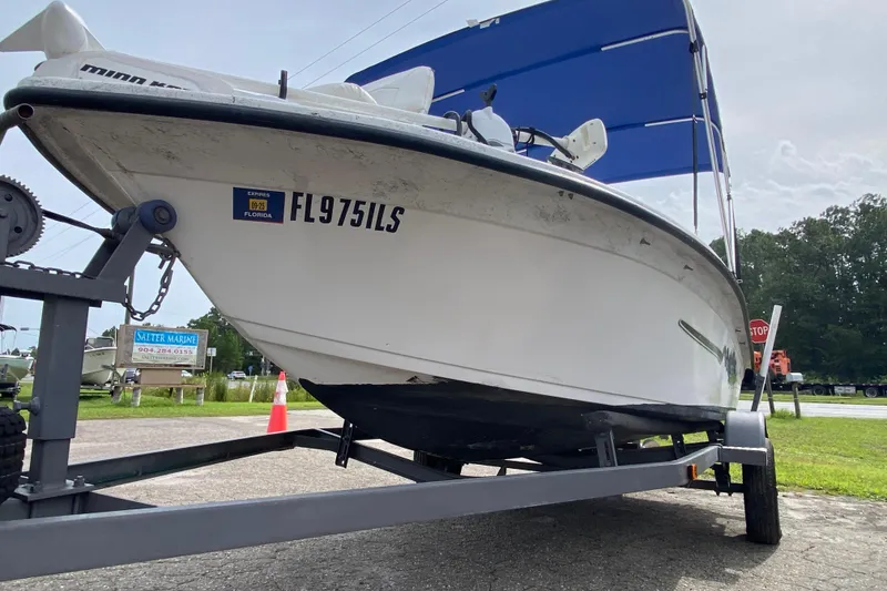 Slide: The Image of 2002 Carolina Skiff 175 boat on trailer, Florida registration visible. - 11