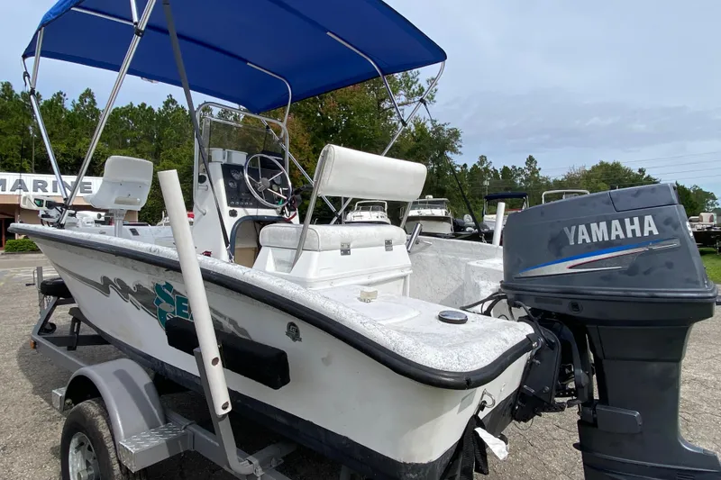 Slide: The Image of 2002 Carolina Skiff 175 boat with Yamaha outboard motor and blue canopy. - 4