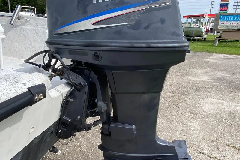 Slide: The Image of 2002 Carolina Skiff 175 with Yamaha outboard motor in a parking lot. - 5