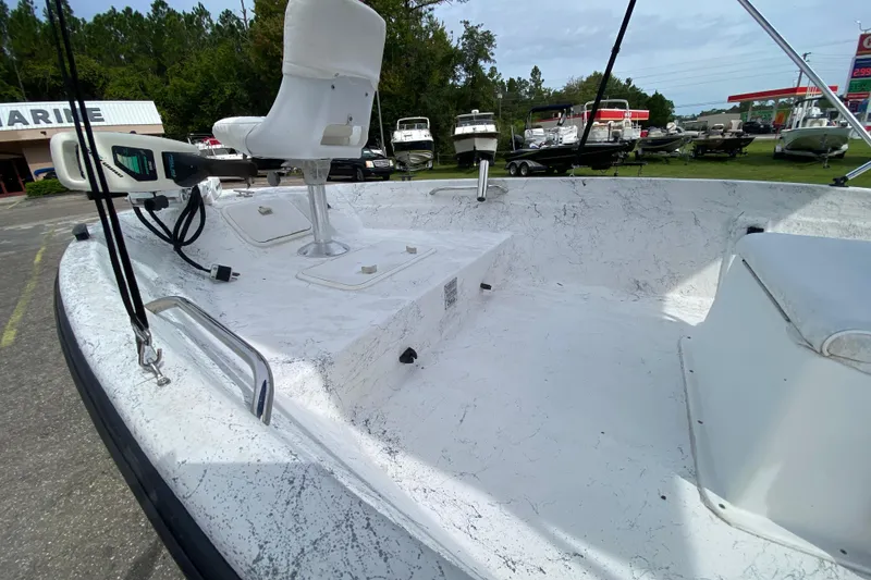 Slide: The Image of 2002 Carolina Skiff 175 boat interior with seating and equipment, parked outdoors. - 9