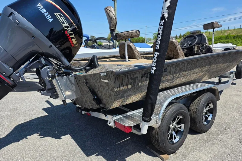 Slide: The Image of 2026 Xpress H20 Bass boat with Yamaha engine on a trailer. - 11