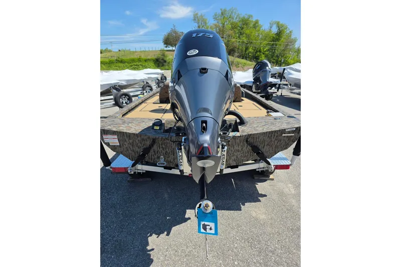 Slide: The Image of 2026 Xpress H20 Bass boat with powerful outboard motor, parked outdoors. - 13