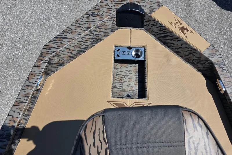 Slide: The Image of 2026 Xpress H20 Bass boat deck with camouflage pattern and seating. - 17